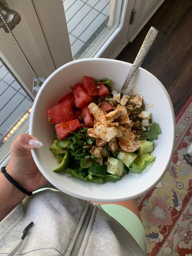 Greens with cucumber, avocado, grilled chicken, seeds, and juicy watermelon cubes.